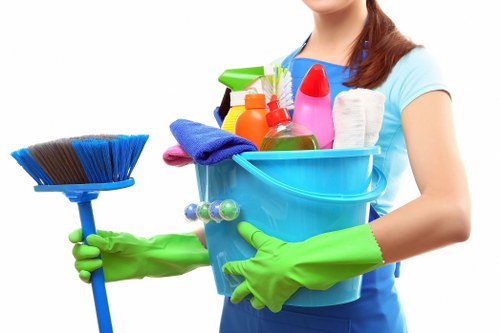 Local cleaner maintaining a modern communal hallway in TW1
